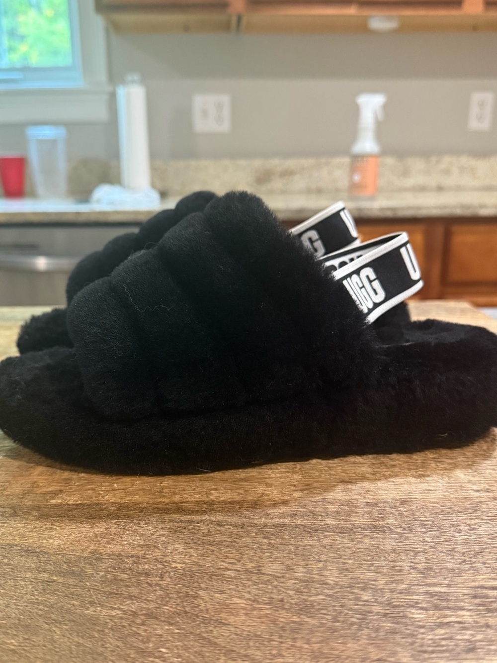 UGG Fluff Yeah Slides featuring soft sheepskin and an elastic logo slingback str